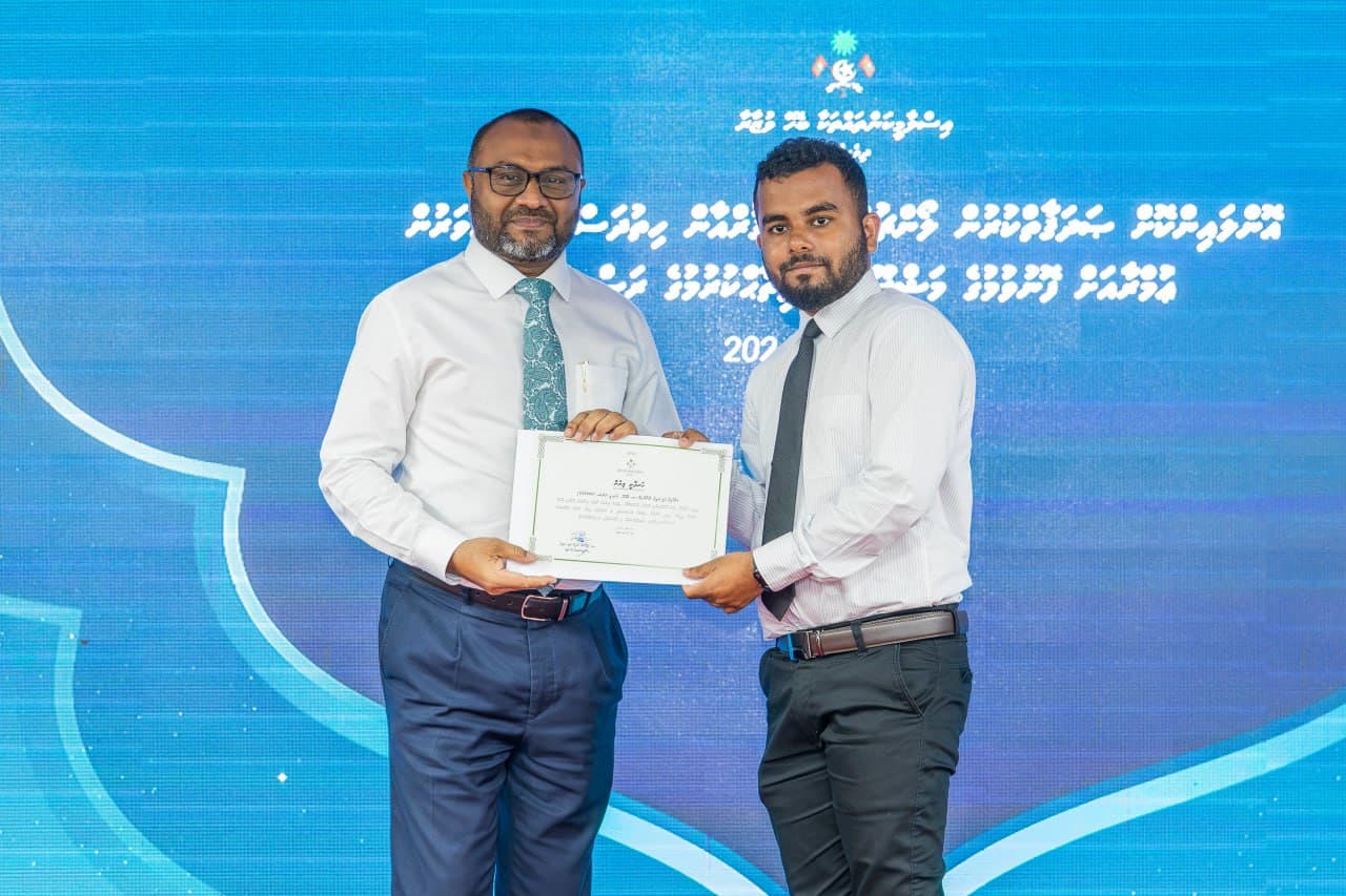 އަލްޙާފިޡް ޢަލީ ރަޢީފު ޢުމްރާއަށް ފޮނުވުމުގެ ލިޔުން ހަވާލުކުރަނީ. ފޮޓޯ: މިނިސްޓްރީ